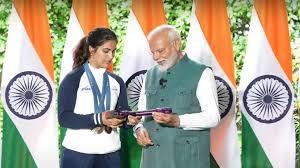 Manu Bhaker introduces pistol that won her two Olympic medals to PM Modi.